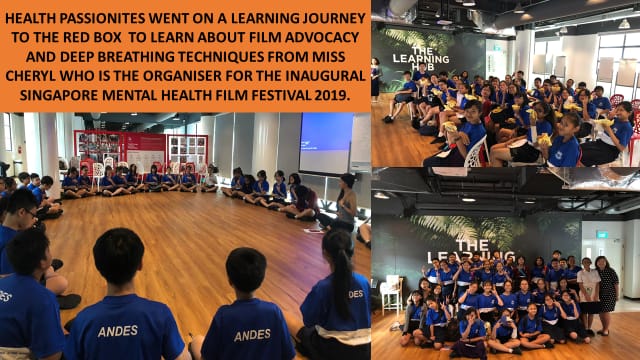 Students in blue shirts sit in a circle and gather in a modern space called The Learning Hub.